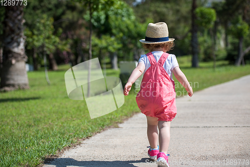 Image of little girl runing in the summer Park