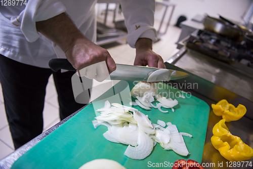 Image of Chef hands cutting fresh and delicious vegetables