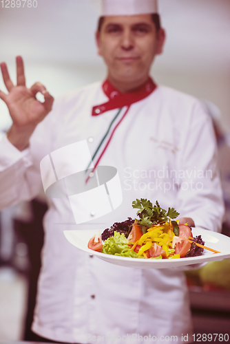 Image of Chef showing a plate of tasty meal