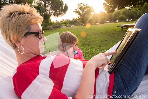 Image of mom and a little daughter relaxing in a hammock