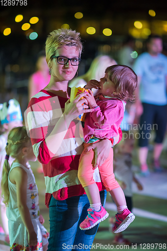 Image of mother and little daughter in the kids disco