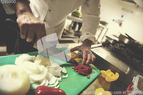 Image of Chef hands cutting fresh and delicious vegetables