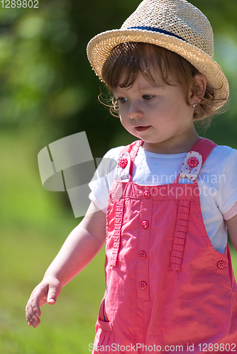 Image of little girl runing in the summer Park