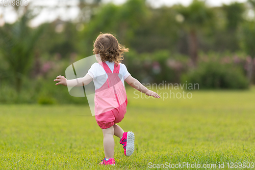 Image of little girl spending time at backyard