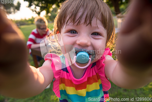 Image of little girl spending time at backyard