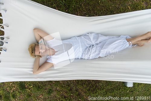 Image of young woman resting on hammock