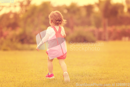 Image of little girl spending time at backyard