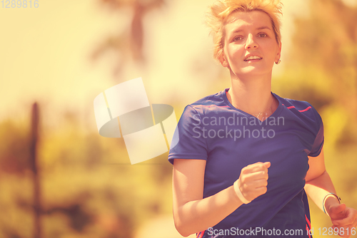 Image of young female runner training for marathon