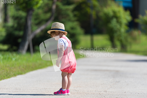 Image of little girl runing in the summer Park