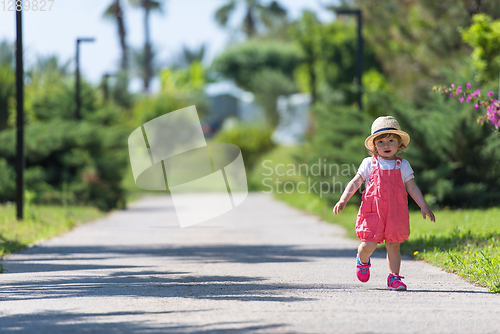 Image of little girl runing in the summer Park