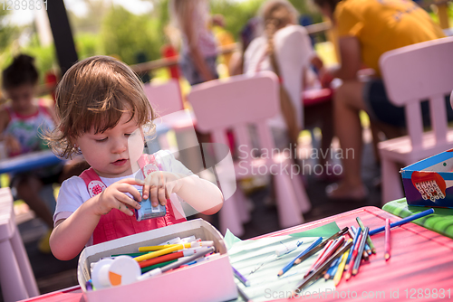 Image of little girl drawing a colorful pictures