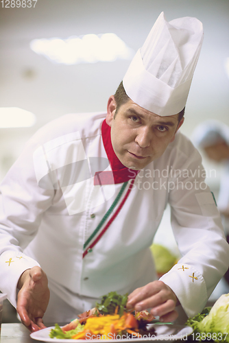 Image of chef serving vegetable salad