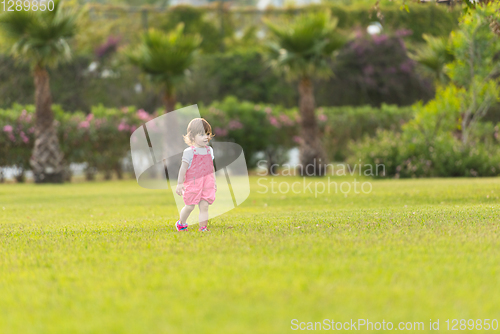 Image of little girl spending time at backyard