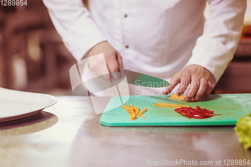 Image of Chef hands cutting fresh and delicious vegetables