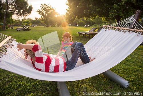 Image of mom and a little daughter relaxing in a hammock