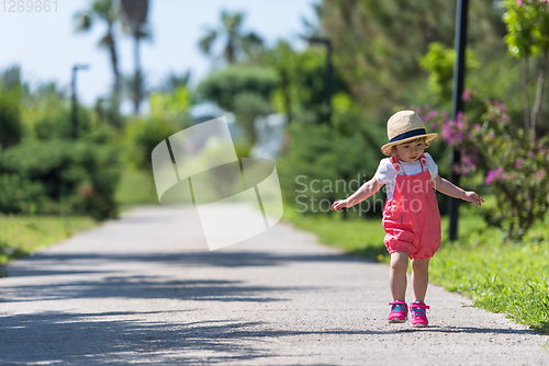 Image of little girl runing in the summer Park