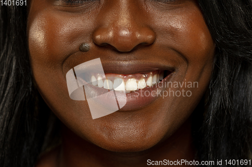 Image of Young african woman isolated on yellow studio background, facial expression
