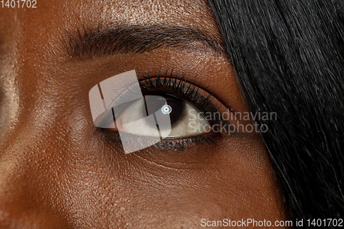 Image of Young african woman isolated on yellow studio background, facial expression