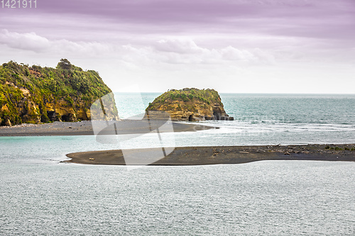 Image of sea shore rocks and mount Taranaki, New Zealand