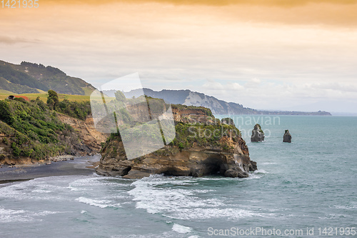 Image of sea shore rocks and mount Taranaki, New Zealand