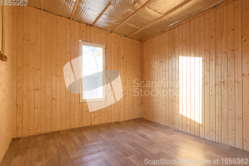 Image of Empty room in a country house, sun rays fall on the wall from the window