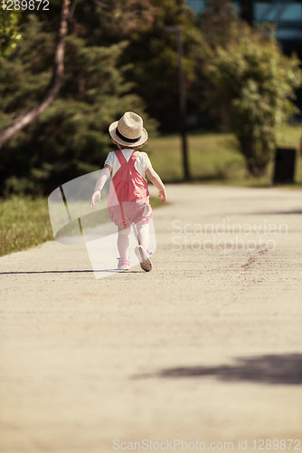 Image of little girl runing in the summer Park