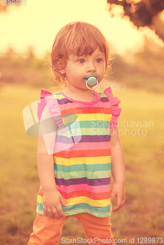 Image of little girl spending time at backyard