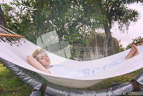 Image of young woman resting on hammock