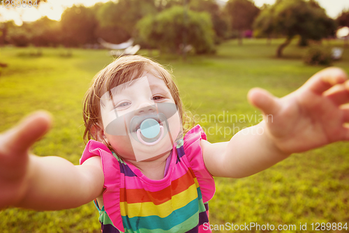 Image of little girl spending time at backyard