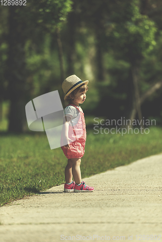 Image of little girl runing in the summer Park