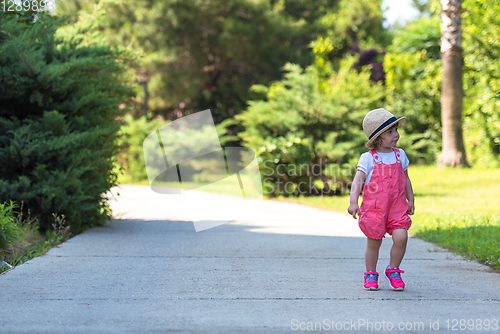 Image of little girl runing in the summer Park