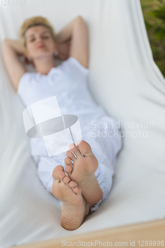 Image of young woman resting on hammock