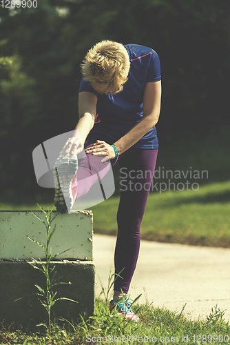 Image of female runner warming up and stretching