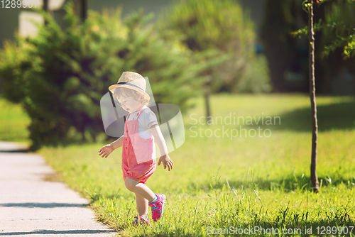 Image of little girl runing in the summer Park