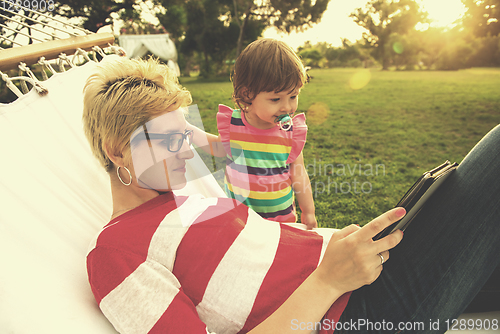 Image of mom and a little daughter relaxing in a hammock