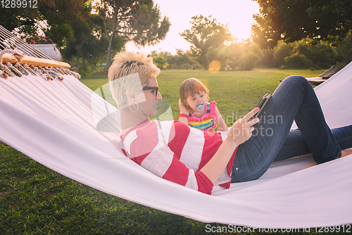 Image of mom and a little daughter relaxing in a hammock