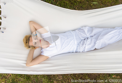 Image of young woman resting on hammock