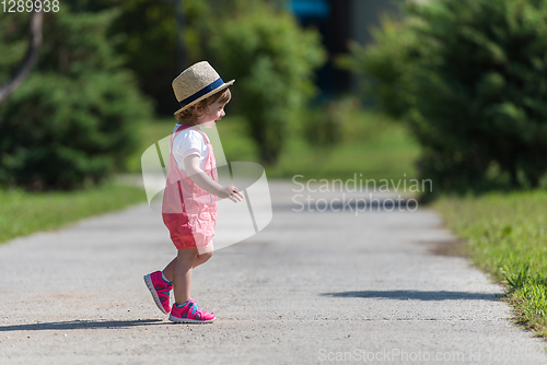 Image of little girl runing in the summer Park