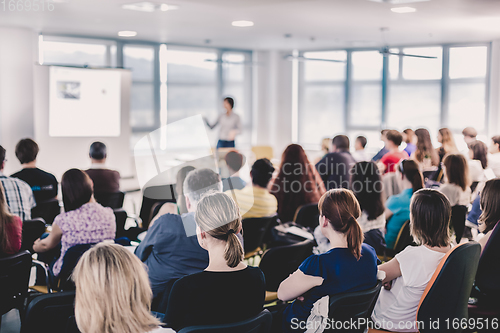 Image of Speaker giving presentation on business conference.