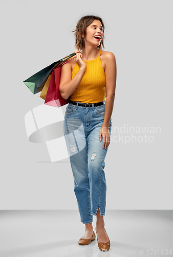 Image of happy smiling young woman with shopping bags