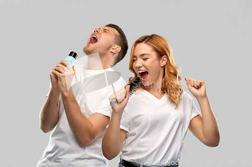 Image of happy couple singing to hairbrush and lotion