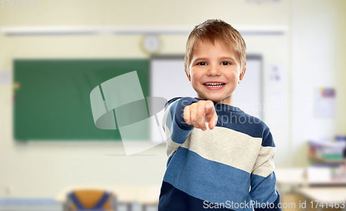 Image of little boy pointing finger at school