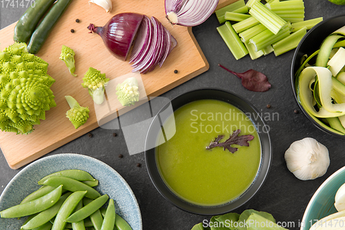 Image of green vegetables and cream soup in ceramic bowl