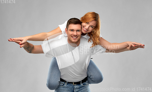 Image of happy couple in white t-shirts having fun