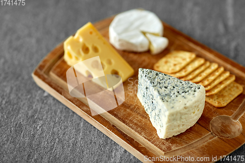 Image of close up of blue cheese on wooden cutting board