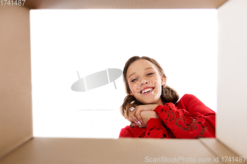 Image of happy young woman looking into open gift box