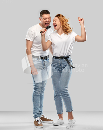 Image of happy couple singing to hairbrush