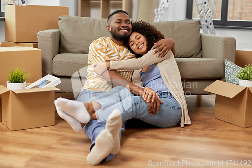 Image of happy couple with boxes moving to new home