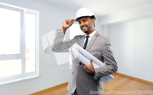 Image of indian male architect in helmet with blueprints