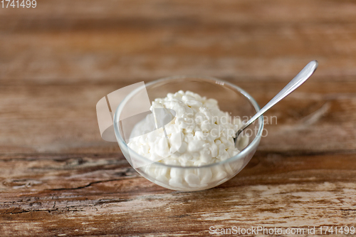 Image of close up of cottage cheese in bowl on wooden table